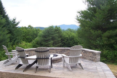 Foto de patio tradicional de tamaño medio sin cubierta en patio trasero con brasero y adoquines de piedra natural