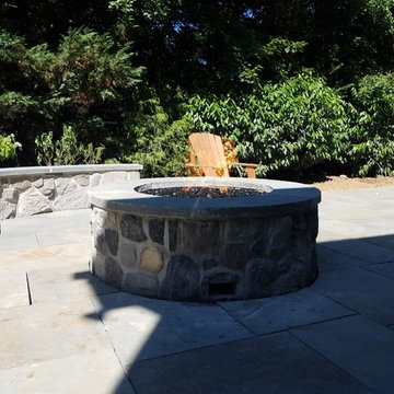 Patio with stone wall and fire pit
