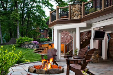 Patio - large transitional backyard brick patio idea in Portland with a fire pit and no cover