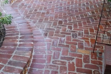 Inspiration for a mid-sized transitional side yard brick patio remodel in Los Angeles with no cover