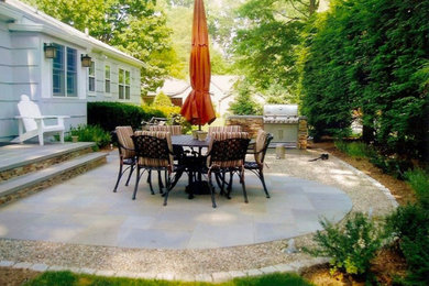 Inspiration for a mid-sized backyard concrete paver patio kitchen remodel in New York with no cover
