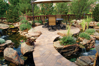 Backyard concrete paver patio photo in Other