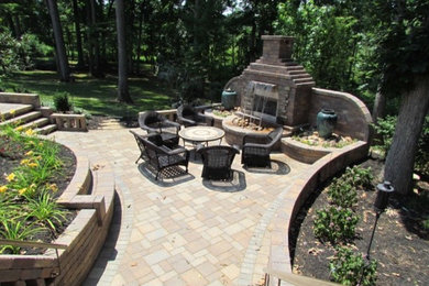 Patio - mid-sized backyard brick patio idea in DC Metro with a fire pit and no cover