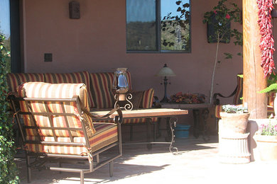 Patio - mid-sized backyard concrete paver patio idea in Phoenix with a roof extension