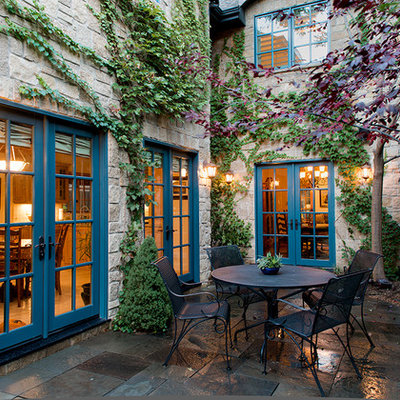 Example of a mid-sized classic side yard stone patio vertical garden design in Denver with no cover