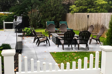 Example of a mid-sized trendy backyard tile patio design in New York with a fire pit and no cover