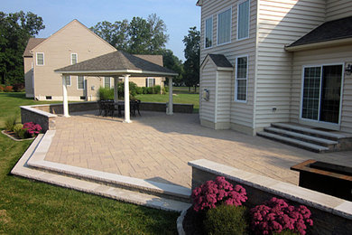 Inspiration for a large timeless backyard concrete paver patio remodel in Philadelphia with a fire pit and a gazebo