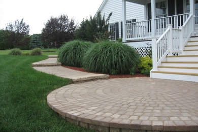 Example of a small arts and crafts front yard concrete paver patio design in Baltimore with a roof extension