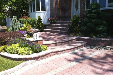 Inspiration for a front yard brick patio remodel in New York