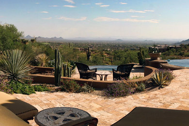 Patio - large traditional backyard stone patio idea in Phoenix with no cover