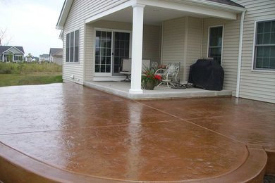 Example of a mid-sized backyard concrete paver patio design in New York with a roof extension