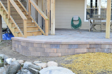 Patio - small craftsman backyard concrete paver patio idea in Detroit with a roof extension