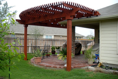 Foto de patio tradicional renovado de tamaño medio en patio trasero con adoquines de ladrillo y pérgola