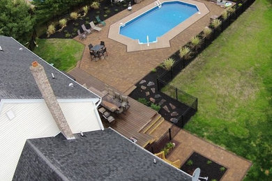 Example of a large trendy backyard concrete paver patio design in Other
