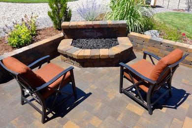 Mid-sized elegant backyard brick patio photo in Denver with a fire pit