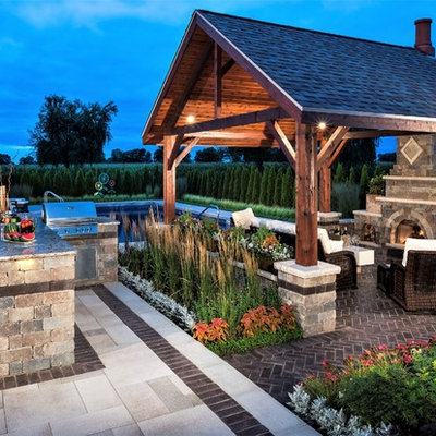 Mid-sized elegant backyard brick patio kitchen photo in Chicago with a gazebo