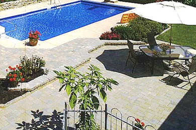 Photo of a back patio in New York with a water feature and concrete paving.