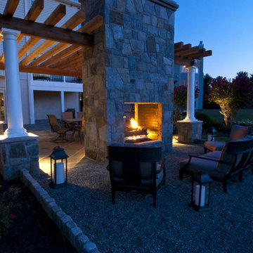 Pea gravel seating area with double sided outdoor fireplace