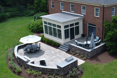 Inspiration for a backyard stone patio kitchen remodel in Philadelphia
