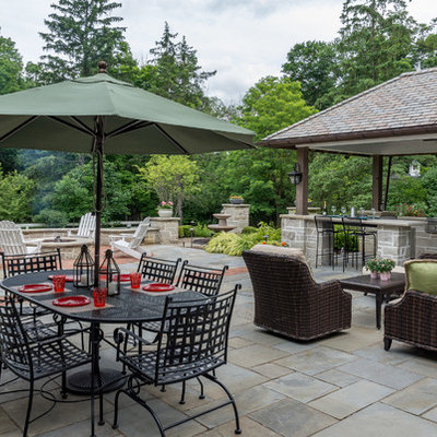 Patio kitchen - mid-sized traditional backyard stone patio kitchen idea with a gazebo