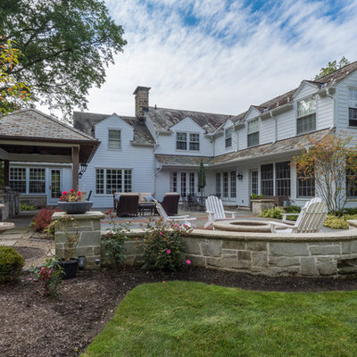 Inspiration for a mid-sized timeless backyard stone patio kitchen remodel in Cleveland with a gazebo