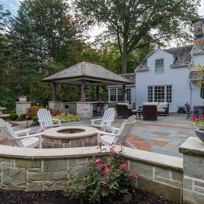 Patio kitchen - mid-sized traditional backyard stone patio kitchen idea in Cleveland with a gazebo