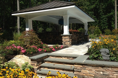 Design ideas for a large traditional back patio in New York with an outdoor kitchen, stamped concrete and a gazebo.