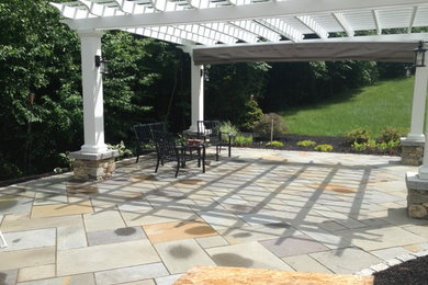 Traditional back patio in Boston with a pergola.