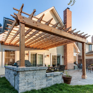 Patio kitchen - traditional backyard patio kitchen idea in Chicago with a pergola