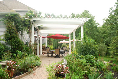 Example of a classic backyard patio design in Philadelphia