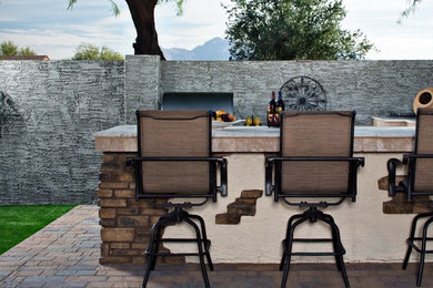 Inspiration for a large mediterranean backyard concrete paver patio kitchen remodel in Phoenix