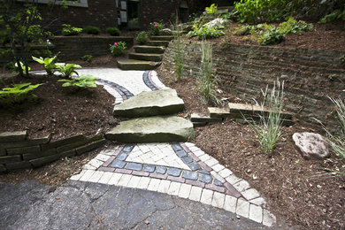 This is an example of an expansive classic back patio in Detroit with a fire feature, brick paving and no cover.