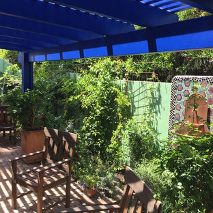 Foto di un piccolo patio o portico boho chic dietro casa con fontane, pavimentazioni in mattoni e una pergola