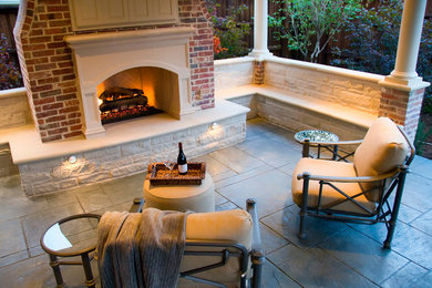 Mid-sized elegant backyard stamped concrete patio photo in Dallas with a fire pit and a roof extension