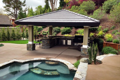 Example of a mid-sized classic backyard stone patio kitchen design in San Francisco with a gazebo