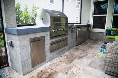 Design ideas for a medium sized modern back patio in Jacksonville with an outdoor kitchen.