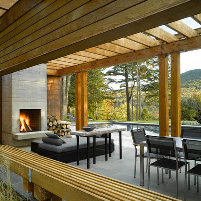 Trendy patio photo in Burlington with a fire pit and a pergola