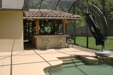 Example of a large beach style backyard concrete paver patio design in Orlando