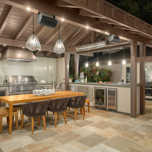 Inspiration for a mid-sized transitional side yard stone patio kitchen remodel in San Francisco with a gazebo
