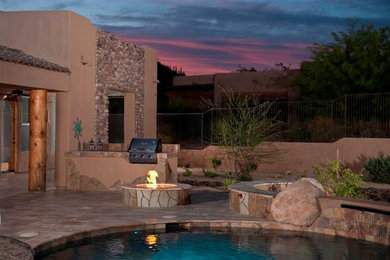 Inspiration for a mid-sized backyard tile patio remodel in Phoenix with a fire pit and a roof extension