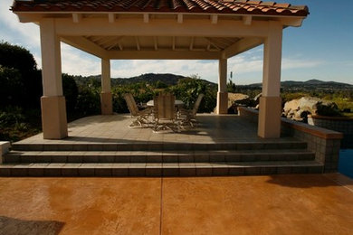 Example of a mid-sized classic backyard concrete patio design in San Diego with a gazebo