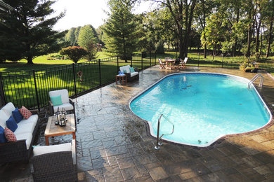 Inspiration for a large timeless backyard pool remodel in Other