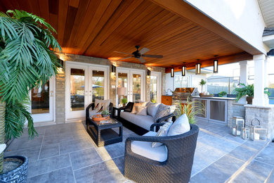 This is an example of a medium sized modern back patio in Toronto with tiled flooring and a roof extension.