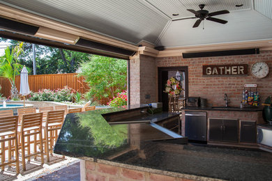 Inspiration for a large contemporary backyard stamped concrete patio kitchen remodel in Dallas with a gazebo