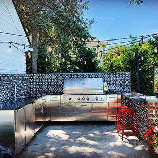 Mid-sized transitional concrete paver patio kitchen photo in New York with no cover