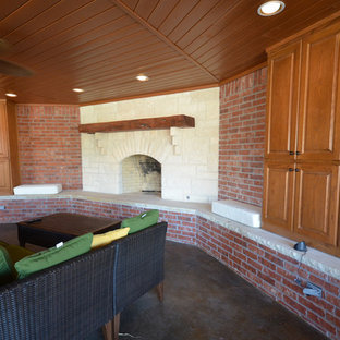 Example of a mid-sized arts and crafts backyard concrete patio kitchen design in Austin with a pergola
