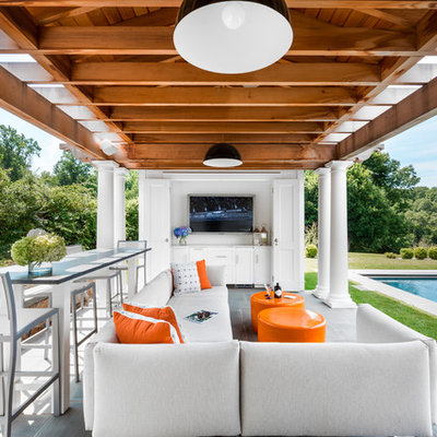 Inspiration for a mid-sized transitional backyard concrete paver patio remodel in New York with a gazebo