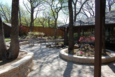 Large backyard brick patio photo in Dallas
