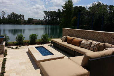 Large backyard tile patio photo in Houston with a fire pit