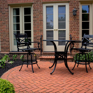 Large traditional courtyard patio in Columbus with brick pavers and no cover.